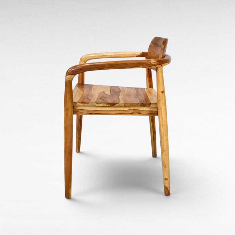 Chora Barefoot Luxury Living handcrafted teak wood chair with natural grain and warm honey tones, side view.