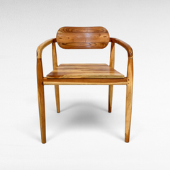 Chora Barefoot Luxury Living handcrafted teak wood chair with natural grain and warm honey tones in a minimalist style.