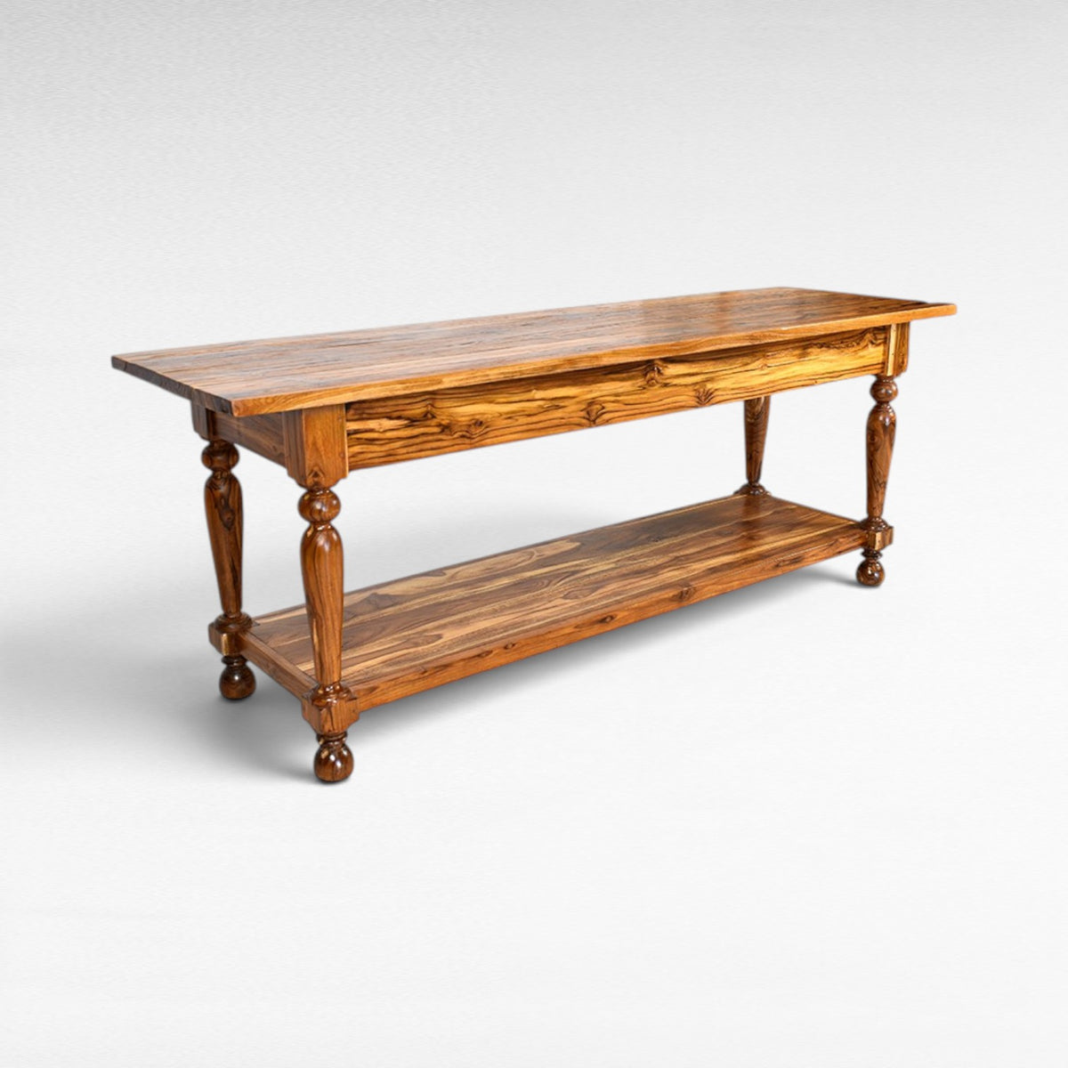 Chora Barefoot Luxury Living console table made of teak wood with turned legs and a lower shelf.