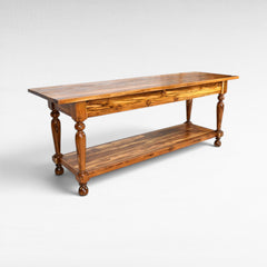 Chora Barefoot Luxury Living console table made of teak wood with turned legs and a lower shelf.