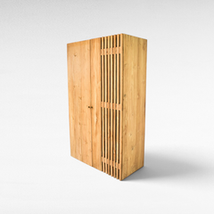 Chora Barefoot Luxury Living handcrafted teak wood wardrobe with natural honey grain and vertical slat detailing.