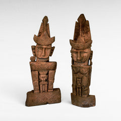 Chora Barefoot Luxury Living set of two carved teak wooden totems with intricate patterns and headdresses, depicting ancestral figures.