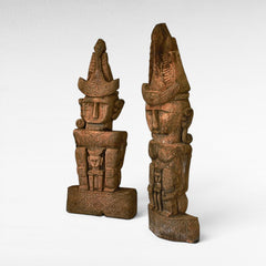 Chora Barefoot Luxury Living set of two carved teak wooden totems with intricate patterns and headdresses.