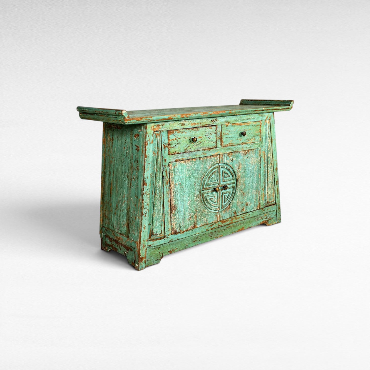 Chora Barefoot Luxury Living distressed teal wooden buffet with two drawers and carved circular motif on doors.
