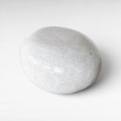 Chora Barefoot Luxury Living terrazzo stool in dirty white, featuring a smooth, pebble-like organic shape.