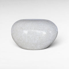 Chora Barefoot Luxury Living terrazzo stool in dirty white with a smooth, rounded pebble-like shape.