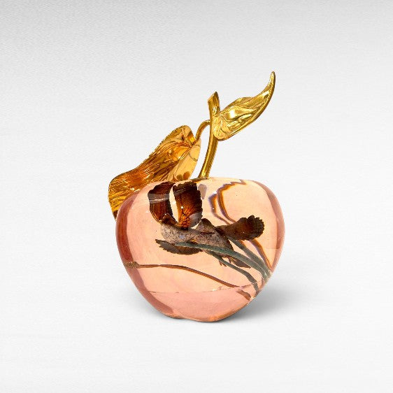 Chora Barefoot Luxury Living decorative transparent pink apple with gold leaf stem and two birds inside.