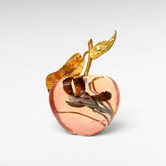 Chora Barefoot Luxury Living decorative transparent pink apple with gold leaf stem and two birds inside.