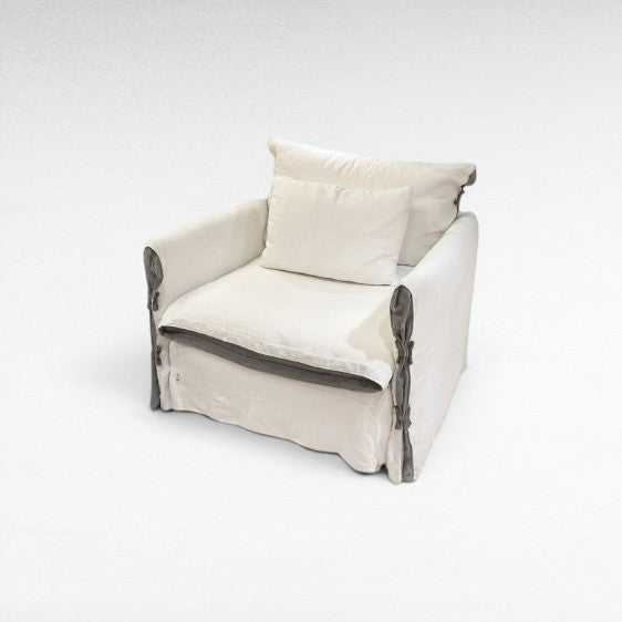 Chora Barefoot Luxury Living white organic linen armchair with grey accents and two pillows. Relaxed, slipcovered style.