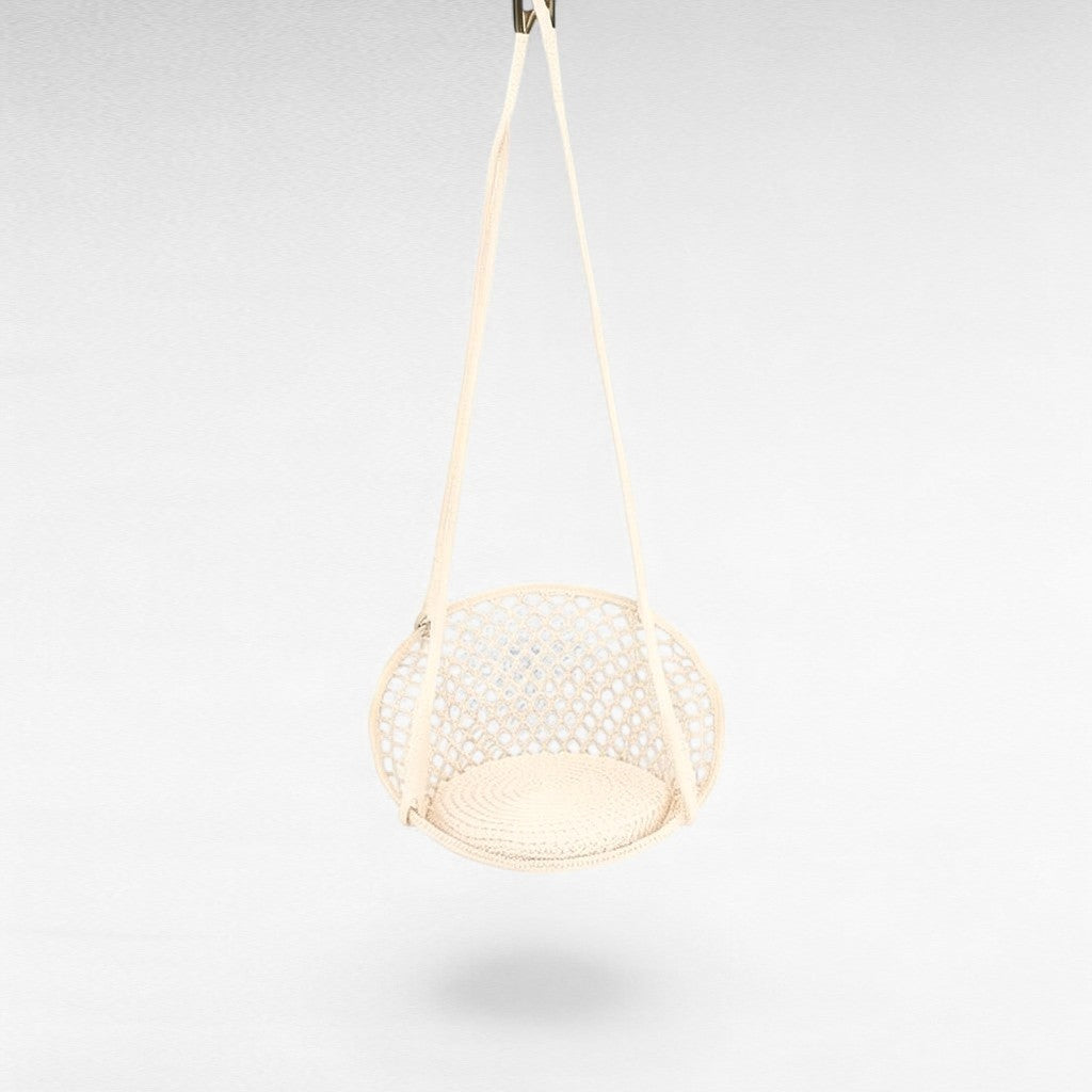 Chora Barefoot Luxury Living white macrame rope hammock swing with a circular woven seat pad for indoor relaxation.