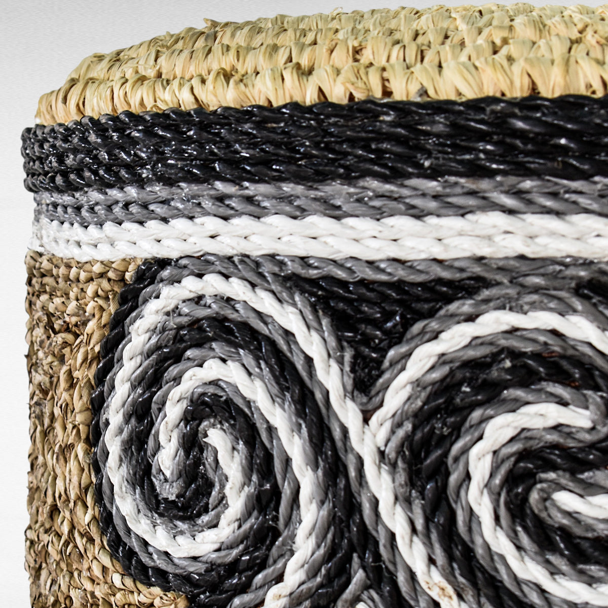 Chora Barefoot Luxury Living stool featuring natural grass, black and white rope detailing in a swirling pattern.