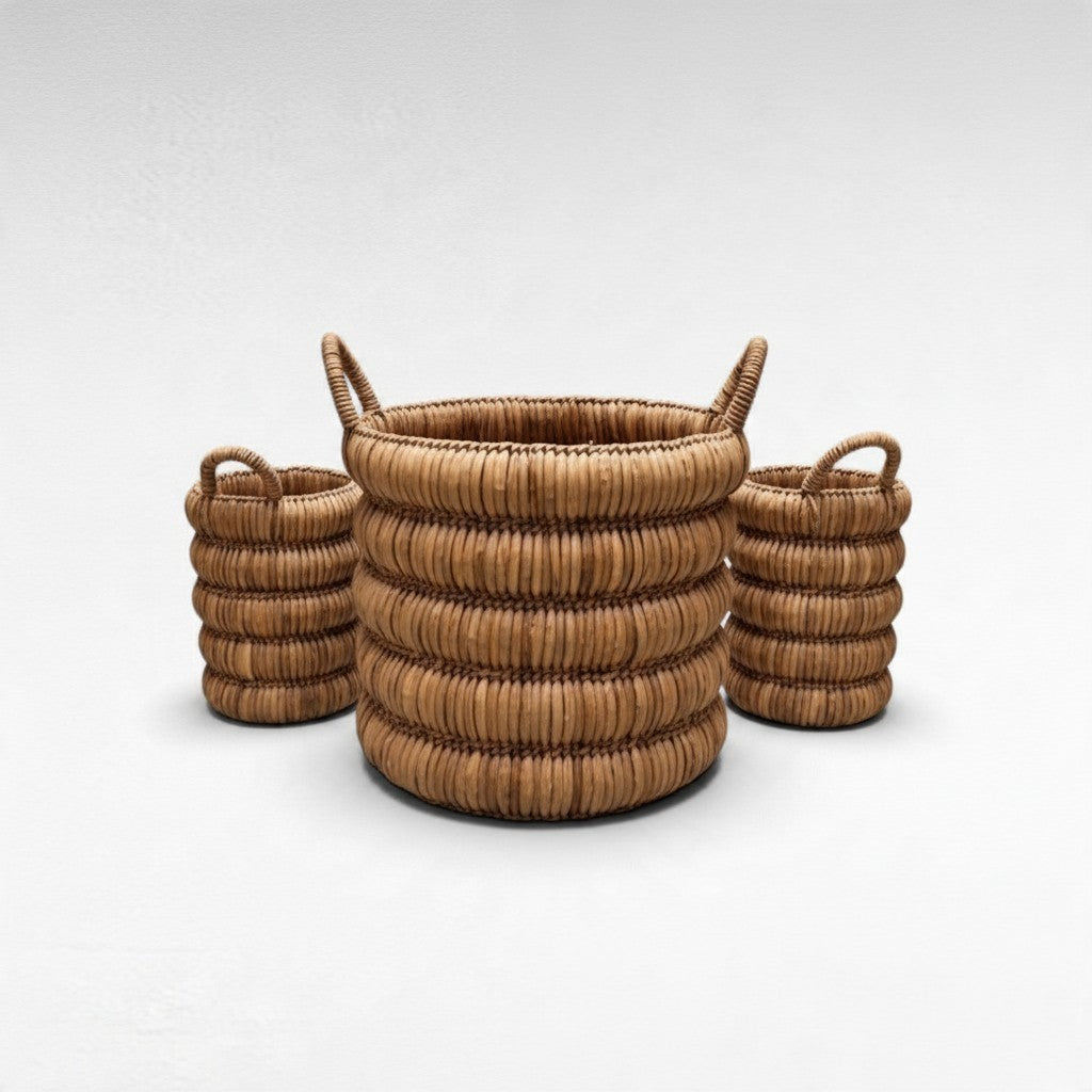 Chora Barefoot Luxury Living set of three round woven rattan baskets with handles in a natural light brown finish