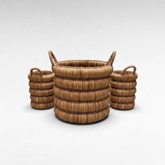 Chora Barefoot Luxury Living set of three round woven rattan baskets with handles in a natural light brown finish