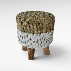 Chora Barefoot Luxury Living round stool with a woven natural seagrass top and white rope base on wooden legs