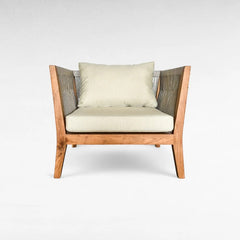 Chora Barefoot Luxury Living armchair with light beige cushions and woven grey sides, made of wood.
