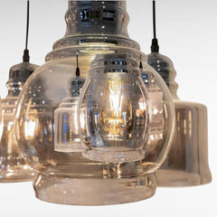 Chora Barefoot Luxury Living reflective black metal and glass pendant light with vintage bulbs.