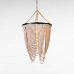 Chora Barefoot Luxury Living Ivory Cascade beaded chandelier with loops of wooden beads on a metal frame.
