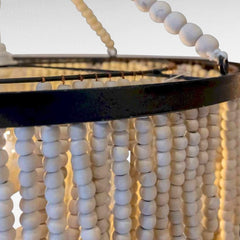Chora Barefoot Luxury Living Ivory Cascade beaded chandelier with loops of wooden beads on a metal frame.