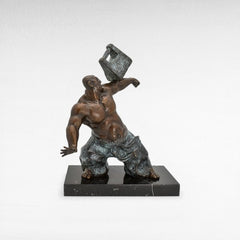Chora Barefoot Luxury Living bronze sculpture of a muscular man lifting a heavy weight, symbolizing strength and determination.