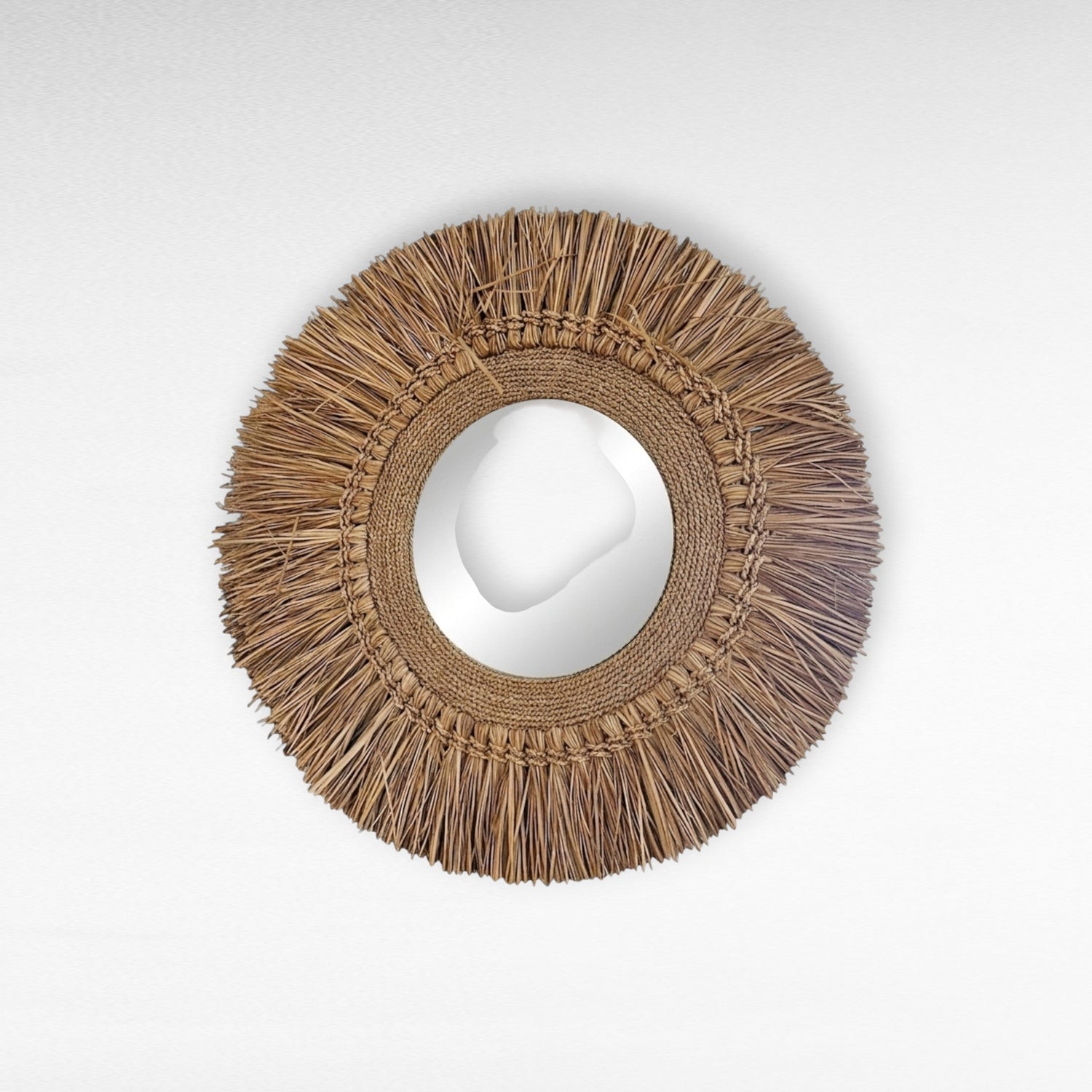 Chora Barefoot Luxury Living round raffia mirror with fringe detail, natural woven texture, bohemian style.