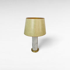 Chora Barefoot Luxury Living white and gold marble metal table lamp with a textured cream lampshade.