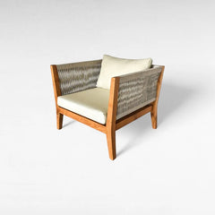 Chora Barefoot Luxury Living natural wood armchair with woven rope sides and cream cushions.