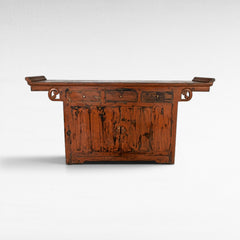 Chora Barefoot Luxury Living antique red distressed wood buffet with three drawers and double doors, ornate carved details.