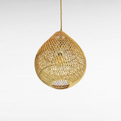 Chora Barefoot Luxury Living natural rattan oval pendant light with woven texture and exposed bulb