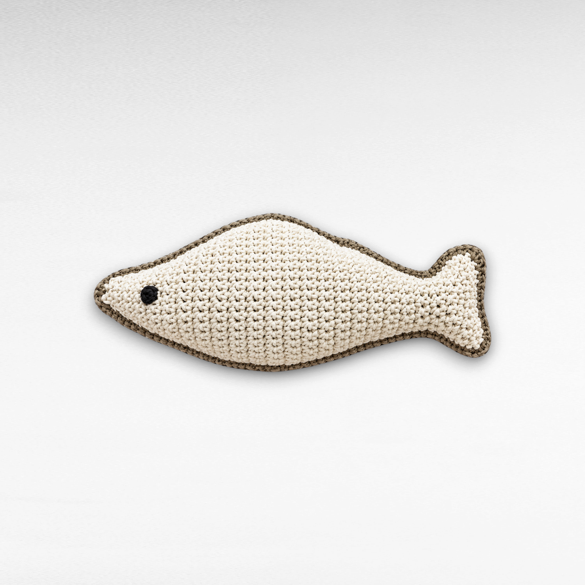 Chora Barefoot Luxury Living large fish-shaped crochet pillow in natural cream with a dark brown trim and black eye.